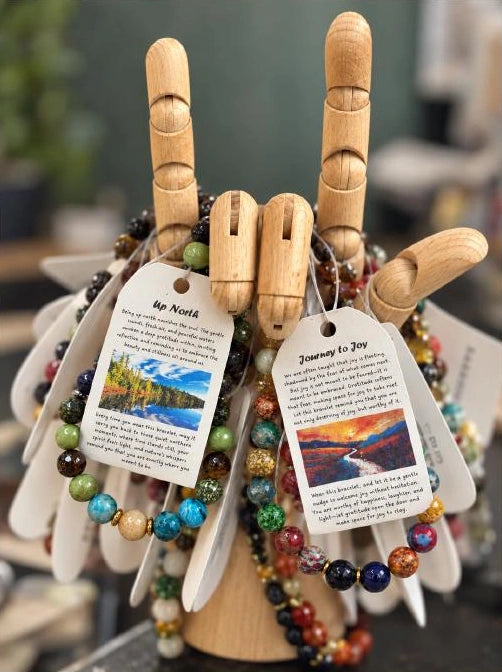 EOS bracelets and their printed story tags on a wooden display.